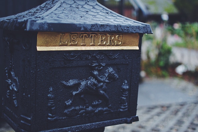 intricate mailbox with the word letters inscribed on the top