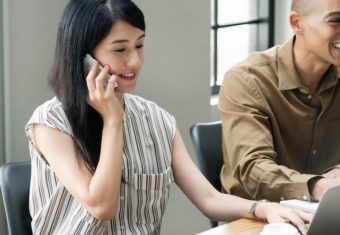 professional woman in an office talking on a cell phone