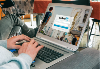 Man on a laptop uploading his resume on LinkedIn