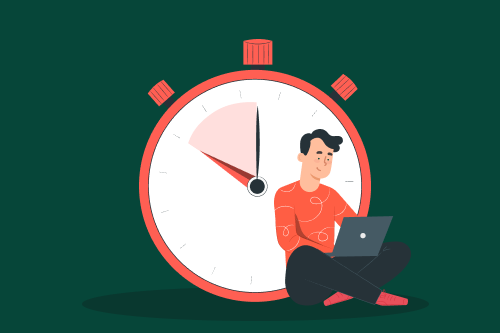 A man works on his laptop in front of a large clock