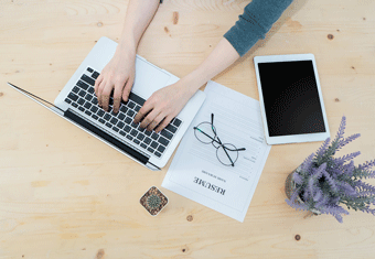 A job seeker types their resume