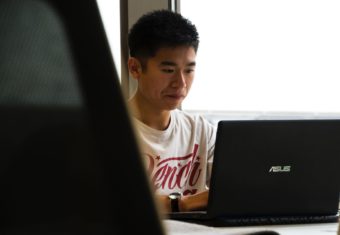 Man writing on a laptop
