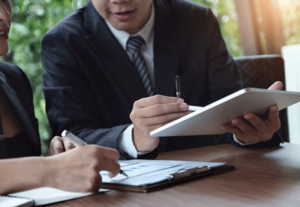Administrative assistant receives instructions from his boss An administrative assistant consults his boss before he starts his next task