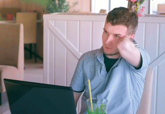An amputee job seeker works on his resume on a laptop