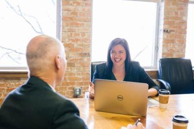 A woman conducting an interview with a man who recently learned the top interview tips this year