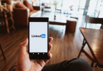 User adding a LinkedIn summary to their LinkedIn profile using a smartphone