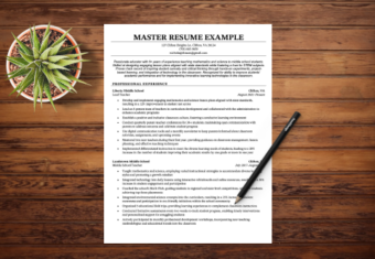 A master resume lying on a table with a pen and a green plant next to it.