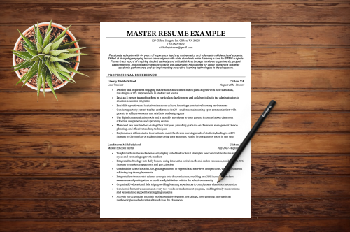 A master resume lying on a table with a pen and a green plant next to it.