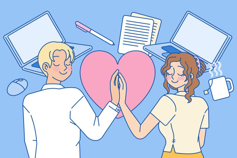 2 U.S. coworkers holding hands in a workplace setting